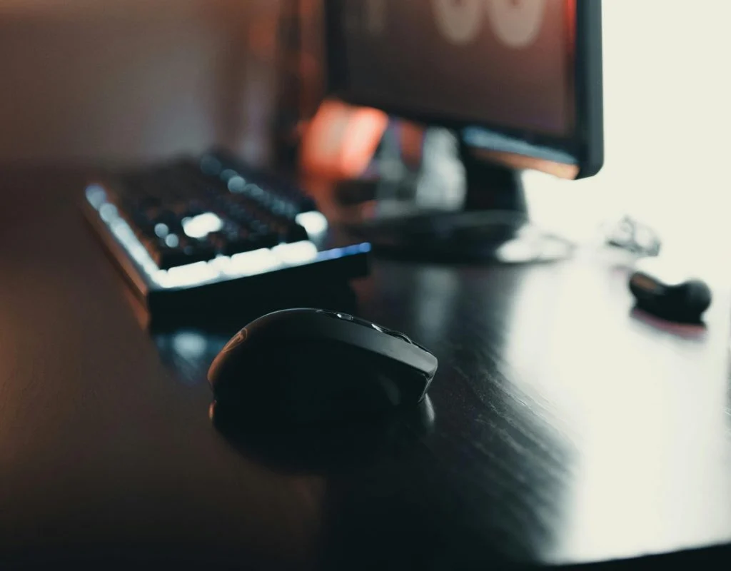 Person buying a desktop PC with monitor, keyboard, and mouse on a desk