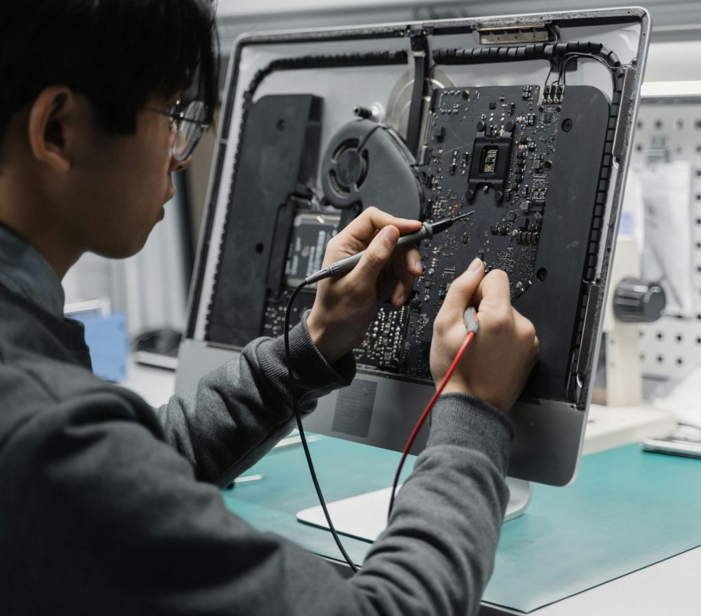 A person inspecting the internal components of a computer