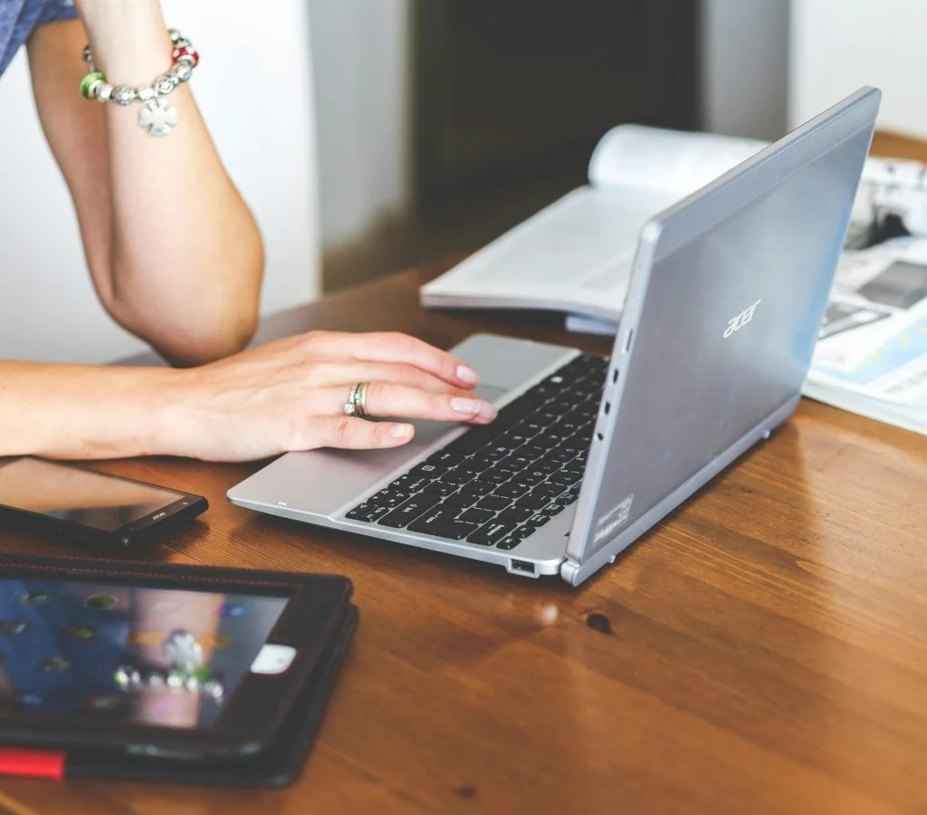 A laptop and desktop computer side by side, highlighting portability