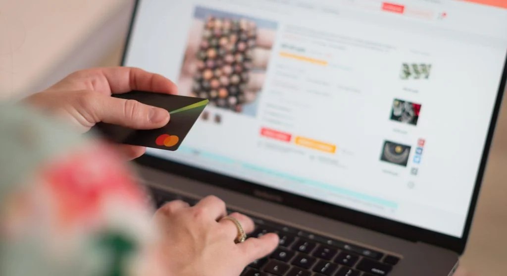 Person checking laptop specifications before buying