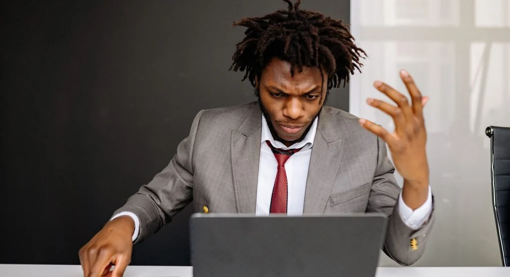 Person frustrated with slow computer loading screen