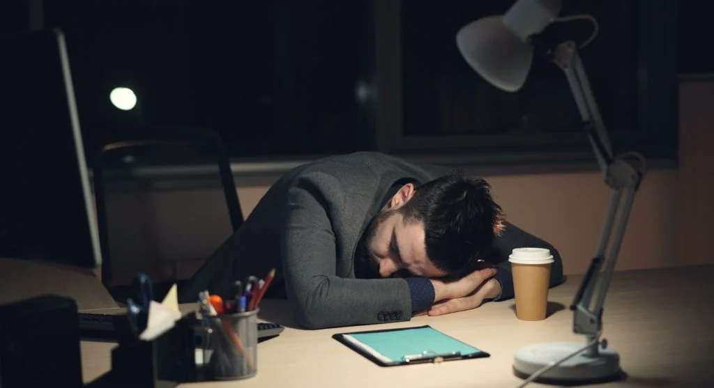 person using multiple screens and devices